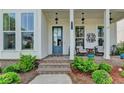 Inviting front porch with brick steps and space for relaxing at 1002 Harvest Park Ln, Suwanee, GA 30024