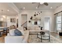 Spacious living room open to kitchen with white section and hardwood floors at 1002 Harvest Park Ln, Suwanee, GA 30024