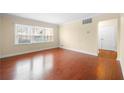A bright living room features large windows with natural light and hardwood floors at 2355 Henderson Mill Ne Rd # 6, Atlanta, GA 30345