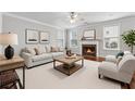 Bright living room features neutral walls, fireplace, plush seating, and large windows for abundant natural light at 3134 Flery Way, Lawrenceville, GA 30046