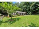 Landscaped front lawn and covered front porch of this brick home at 4371 N Park Dr, Tucker, GA 30084