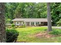 Charming brick home with well-manicured lawn and covered parking at 4371 N Park Dr, Tucker, GA 30084