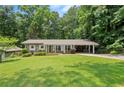 Charming brick home with well-manicured lawn and covered parking at 4371 N Park Dr, Tucker, GA 30084
