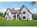 Beautiful stone and brick home featuring black-framed windows and pristine landscaping at 4539 Braselton Hwy, Hoschton, GA 30548