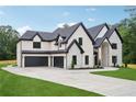 Spacious brick home featuring a three-car garage and a concrete driveway at 4539 Braselton Hwy, Hoschton, GA 30548