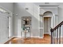 Elegant foyer featuring hardwood floors, decorative mirror and an open archway at 708 Edgeley Ln, Lawrenceville, GA 30044