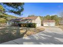 Charming single-story home with a spacious yard and detached garage at 140 Moseley Dr, Stockbridge, GA 30281