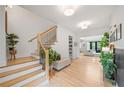 Inviting foyer with hardwood floors, staircase, and a view to the living room at 200 Whispering Pines Dr, Woodstock, GA 30188