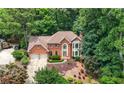 Beautiful brick home nestled among lush trees on a landscaped lot at 3741 Bays Ferry Way, Marietta, GA 30062