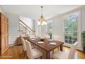 Bright dining room with hardwood floors, large windows, classic chandelier and a staircase visible at 3741 Bays Ferry Way, Marietta, GA 30062