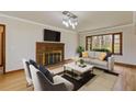 Spacious living room features a fireplace, large window, neutral paint, and hardwood floors at 1312 Milstead Ave, Conyers, GA 30012