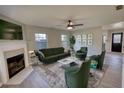 Inviting living room with fireplace, plush green seating, stylish decor, and a view of the front yard at 1700 Conductor Ln, Conyers, GA 30013
