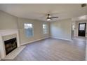 Bright living room with wood-look floors, a fireplace, neutral walls, and plenty of natural light at 1700 Conductor Ln, Conyers, GA 30013
