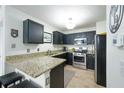 Modern kitchen with granite counters, stainless steel appliances, and a breakfast bar at 2305 Keenland Ct, Cumming, GA 30040