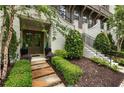Landscaped entrance featuring stone walkway and garden leading to a stylish front door at 6613 Encore Blvd, Atlanta, GA 30328