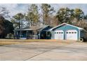 Lovely blue home with an attached two-car garage and a spacious driveway at 110 Fox Meadow Dr, Covington, GA 30016