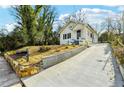 Charming home with freshly painted exterior, landscaped front yard, and concrete driveway at 1382 Elizabeth Ln, Atlanta, GA 30344