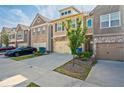 View of modern townhomes, driveways, attached garages, healthy lawns, and diverse architectural facades at 2235 Mulsanne Dr, Lithonia, GA 30058