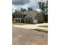 Traditional two-story home with a two-car garage and well-manicured lawn at 5000 Fairview Cir, Villa Rica, GA 30180