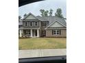 New construction home with brick facade, a covered porch and manicured lawn at 5000 Fairview Cir, Villa Rica, GA 30180