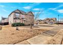 Landscaped front yard of brick home in suburban neighborhood, featuring a sidewalk at 845 Nevis Way, Mcdonough, GA 30253