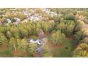Aerial view of home nestled on a large lot surrounded by mature trees at 935 Old Loganville Rd, Loganville, GA 30052