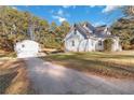 The home features a two-car detached garage and long driveway at 935 Old Loganville Rd, Loganville, GA 30052