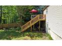 Spacious backyard with deck, stairs, and a newly-installed fence at 1425 Parkmont Dr, Roswell, GA 30076