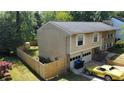 Two-story home featuring attached garage, well-maintained lawn, and a fenced backyard at 1425 Parkmont Dr, Roswell, GA 30076