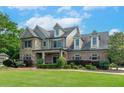 Beautiful exterior home elevation with a large yard, professional landscaping, and inviting curb appeal at 1771 Silvergrass Ln, Grayson, GA 30017