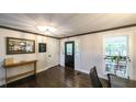 Inviting entryway featuring hardwood floors, decorative mirror, and stylish front door at 180 Mountain Path, Rockmart, GA 30153