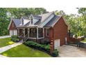 Beautiful brick home featuring a two-car garage, inviting front porch and a well-maintained yard at 180 Mountain Path, Rockmart, GA 30153
