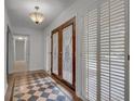 Entryway with decorative double doors, checkered tile, and white walls at 235 Trailmore Ct, Roswell, GA 30076