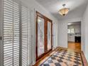 Foyer with decorative glass front door, tile, and a view into the kitchen at 235 Trailmore Ct, Roswell, GA 30076