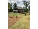Traditional two-story home with a well-manicured lawn and attractive landscaping at 3030 Fairway Dr, Villa Rica, GA 30180