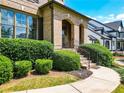 Inviting front entrance with arched brick details, lush landscaping, and well-maintained walkway at 201 Beacon Cv, Canton, GA 30114