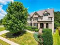 Charming two-story home with manicured lawn, lush landscaping, and classic architectural details at 201 Beacon Cv, Canton, GA 30114