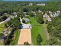 Aerial view showcasing the estate, including horse training area, stables, and fenced acreage at 206 Savanna Estates Ct, Canton, GA 30115