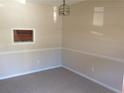 Cozy living room featuring neutral paint and carpet with a pass through window to the kitchen at 3117 Reeves Se St, Smyrna, GA 30080