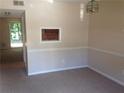 Cozy living room featuring neutral paint and carpet with a pass through window to the kitchen at 3117 Reeves Se St, Smyrna, GA 30080