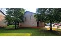 Back of home view of brick and siding with lawn at 5719 Singlebriar Ct, Norcross, GA 30093
