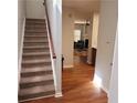 View of carpeted stairs and wood flooring in home's entry way at 5719 Singlebriar Ct, Norcross, GA 30093
