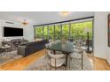 Bright living room featuring hardwood floors, large windows, and modern furnishings at 700 Park Regency Ne Pl # 703, Atlanta, GA 30326