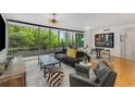 Open-concept living room with floor-to-ceiling windows and contemporary decor at 700 Park Regency Ne Pl # 703, Atlanta, GA 30326