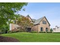 Traditional brick home with lush lawn and mature tree, creating a welcoming entrance at 1800 Hunters Moon Dr, Alpharetta, GA 30005