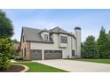 Exterior angle of two-car garage, stone and siding finishes, and chimney at 1800 Hunters Moon Dr, Alpharetta, GA 30005