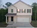 Two-story home with brick and vinyl siding, a two-car garage, and a covered front porch at 558 Fairview Oak Pl, Dallas, GA 30157