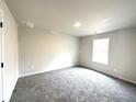 Bedroom with plush carpet, neutral walls, one window, and a ceiling light at 616 Rodeo Dr, Auburn, GA 30011