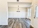 Dining room featuring stylish chandelier, luxury vinyl plank flooring, and abundant natural light at 616 Rodeo Dr, Auburn, GA 30011