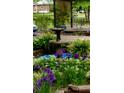 A decorative fountain surrounded by lush plants and purple flowers enhances the curb appeal of the property at 2225 Harold Se Ln, Smyrna, GA 30080